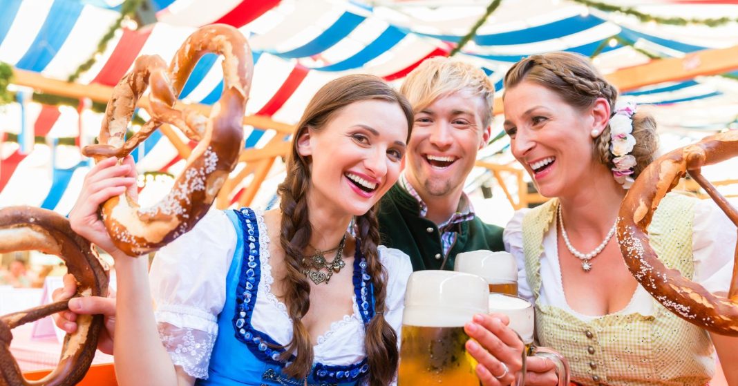 Friends with giant pretzels in Bavarian beer tent