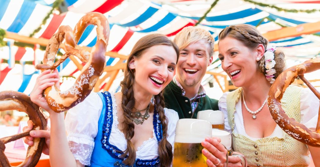 Friends with giant pretzels in Bavarian beer tent